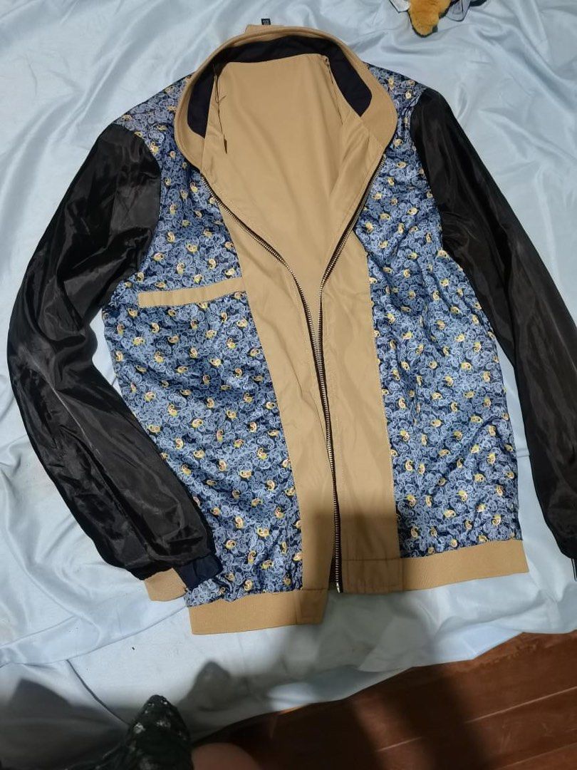 Reversible Bomber Jacket Tan Navy Blue Patterned (Category: Coats, Jackets and Outerwear) located in Manila. Submitted by geminibibo (Listing ID 1470534939, Image 2). Description: Reversible bomber jacket, tan and navy blue panels on one side. Flip it inside out for a blue paisley patterned lining with black sleeves. Zip-up front closure, ribbed cuffs and hem. Functional pockets on the chest and sides. Versatile style, two looks in one jacket..