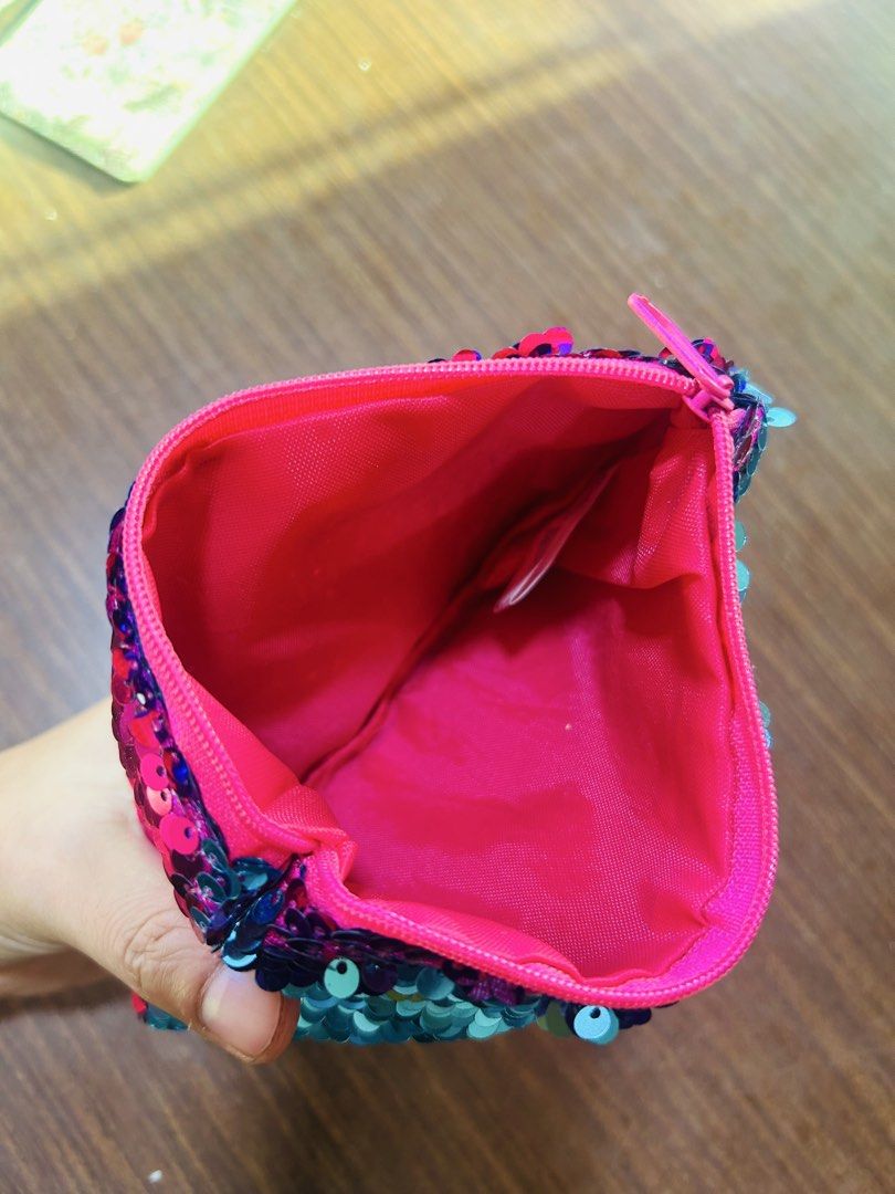 Reversible Sequin LOL Pouch Pink and Teal (Category: Purses & Pouches) located in Manila. Submitted by starbalesukandjapansurplus (Listing ID 1470555717, Image 3). Description: - Fun reversible sequin pouch with LOL lettering - Dual-color design: flip from teal to hot pink sequins - Secure zip top closure with bright pink inner lining - Versatile use for stationery, makeup, or small accessories.