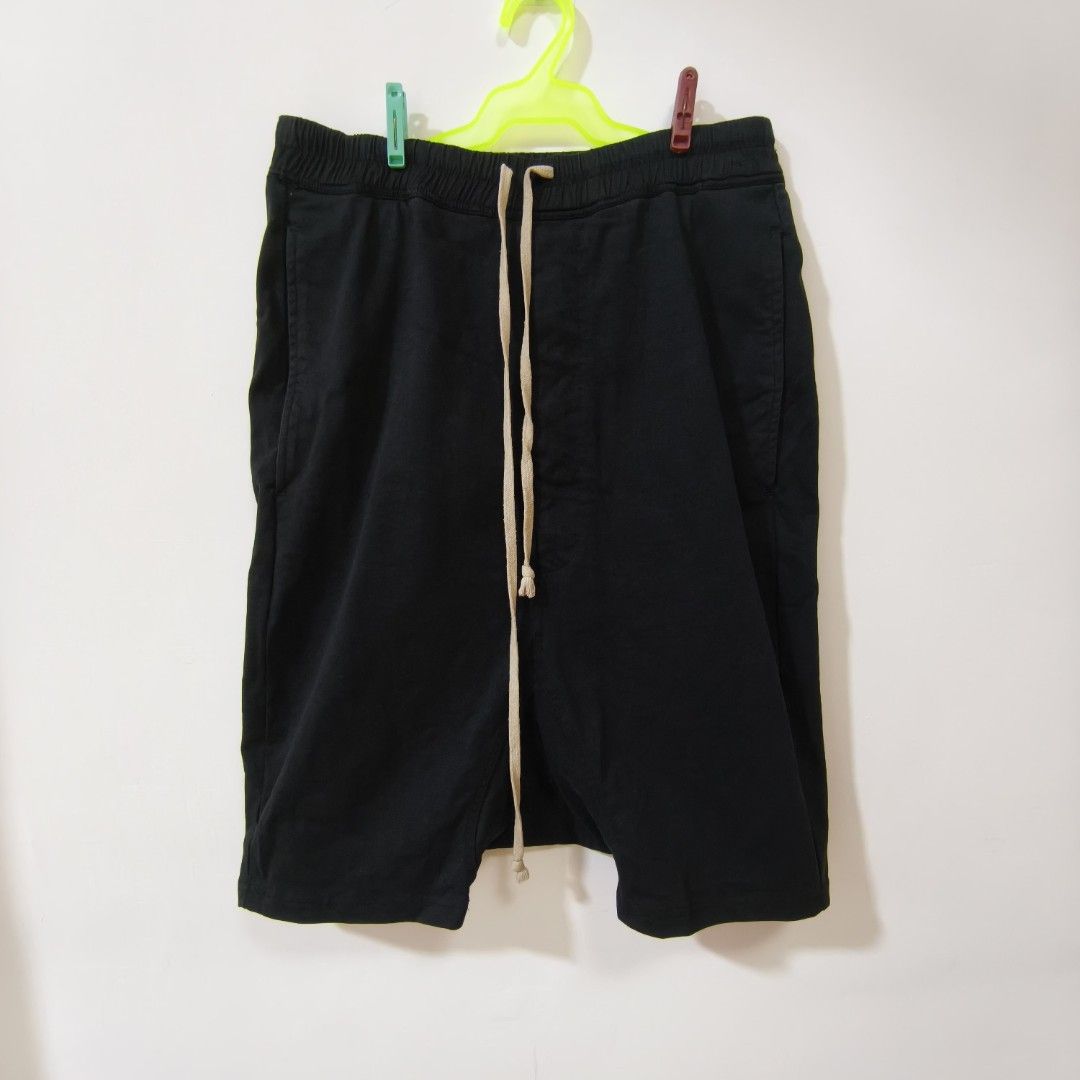 Rick Owen Shorts with Drawstring and Cargo Pockets Black (Category: Shorts) located in Quezon City. Submitted by inrelationthrift (Listing ID 1470425506, Image 1). Description: - Brand: Rick Owen - Color: Black - Material: Comfortable cotton - Waistband: Elastic with long beige front drawstring - Pockets: Two large cargo pockets on the back - Style: Clean finish hems, great for casual everyday wear - Size: Measurements shown in photos - Condition