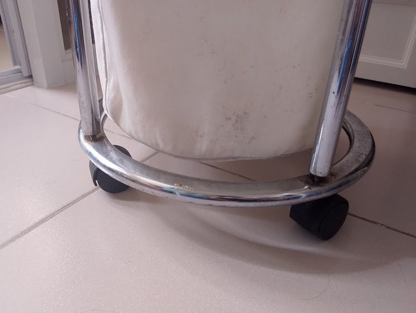 Rolling Chrome Laundry Hamper with Canvas Bag (Category: Laundry Baskets) located in Quezon City. Submitted by susmaryosep1 (Listing ID 1470406817, Image 3). Description: - Type: Round laundry hamper on caster wheels - Material: Chrome metal frame with decorative ball accents and off-white canvas bag - Mobility: Rolls around easily for effortless laundry days - Size: Standard laundry basket size - Condition: Shows some dark spots and stains on th