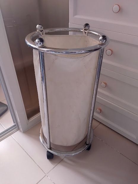 Rolling Chrome Laundry Hamper with Canvas Bag (Category: Laundry Baskets) located in Quezon City. Submitted by susmaryosep1 (Listing ID 1470406817, Image 1). Description: - Type: Round laundry hamper on caster wheels - Material: Chrome metal frame with decorative ball accents and off-white canvas bag - Mobility: Rolls around easily for effortless laundry days - Size: Standard laundry basket size - Condition: Shows some dark spots and stains on th