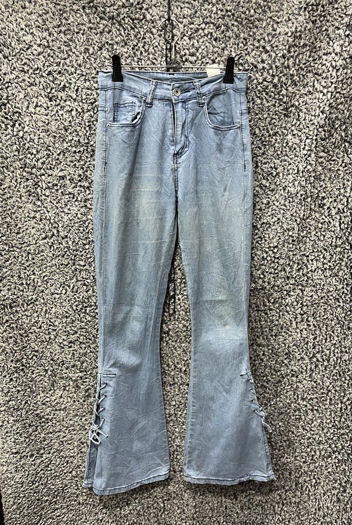 Romwe light-wash flare jeans | Size XS (Category: Jeans) located in General Trias. Submitted by zrchustle.604 (Listing ID 1470495227, Image 2). Description: Romwe light-wash flare jeans featuring adjustable lace-up detailing along the lower outer leg panels. This style blends vintage 2000s Y2K aesthetics with a classic bell-bottom silhouette, making them popular on trendy fashion platforms..