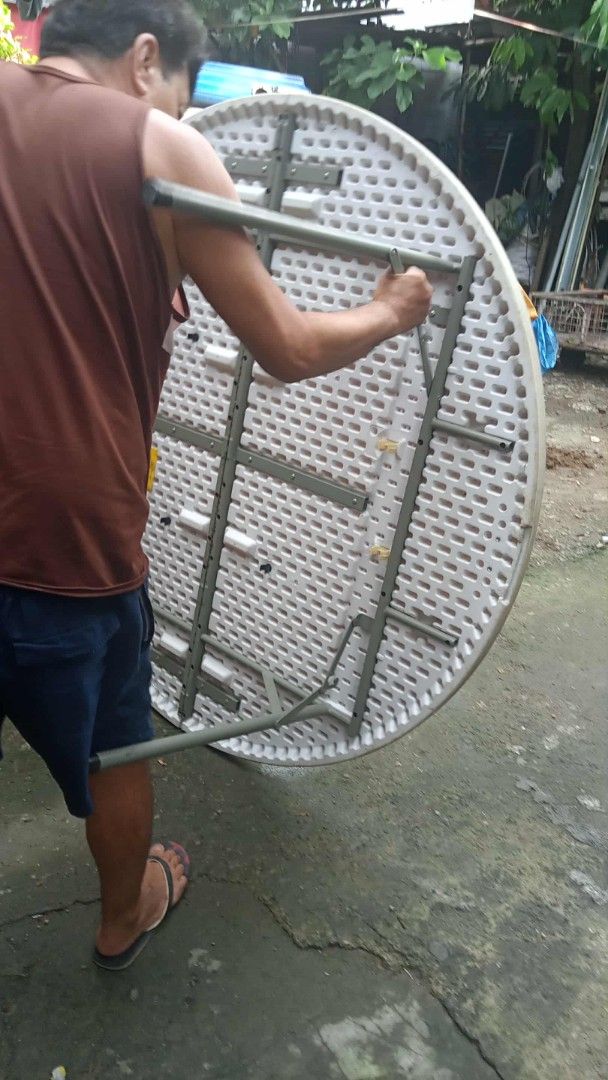 Round Foldable Plastic Event Table with Metal Frame (Category: Tables & Sets) located in Manila. Submitted by wisegem-231b (Listing ID 1470403674, Image 2). Description: - Large round folding table with a durable white plastic top and honeycombed underside structure - Secure grey metal folding legs that lock firmly into place - Conveniently folds in half with a built-in carrying handle for effortless transport and compact storage - Ideal for part