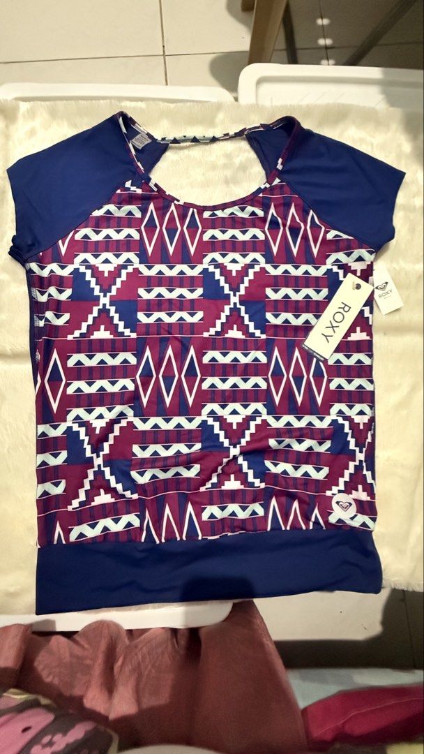 Roxy Aztec Pattern Short Sleeve T-Shirt Drifit (Category: Shirts) located in Makati City. Submitted by Everythingnice2022 (Listing ID 1470528057, Image 3). Description: 38-42 bust 34-36 waist - Brand: Roxy - Condition: Brand new with original paper retail tags - Color: Navy blue with colorful geometric Aztec pattern on front - Size: Number 1 - Material/Tech: Dry Flight technology fabric - Design: Blue cap sleeves, short sleeve - Origin: Made in I