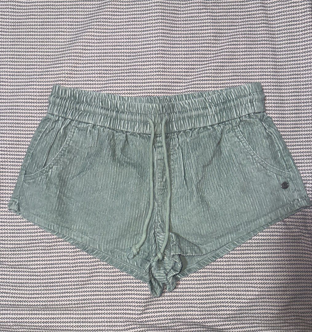 Roxy Green Corduroy Drawstring Shorts (Category: Shorts) located in Santa Ana. Submitted by fatikilla (Listing ID 1470465205, Image 1). Description: - Brand: Roxy - Style: Corduroy shorts in muted green - Size: Medium (AU 10) - Waistband: Elastic with matching drawstring cords - Pockets: Two front pockets - Details: Small branded metal button near the hem - Material: Soft textured fabric - Origin: Made in China.