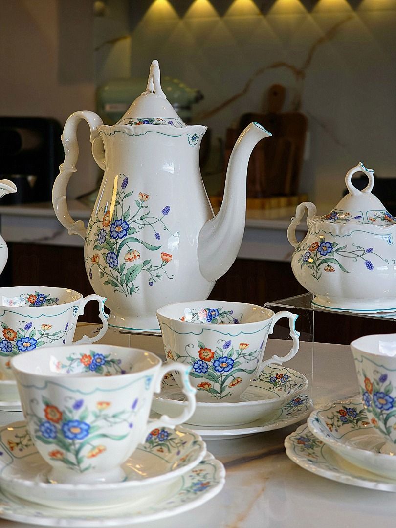 Royal Albert Hamlyn Coffee Set (Category: Coffee & Tea Tableware) located in Compostela. Submitted by curatedcabinetcebu (Listing ID 1470547886, Image 3). Description: - Authentic Royal Albert bone china tea set in Hamlynpattern - Complete 6-person service including large coffee pot, creamer, and lidded sugar bowl - Includes 6 teacups, matching saucers and cake plates - Elegant white background adorned with a vibrant blue and orange floral motif 