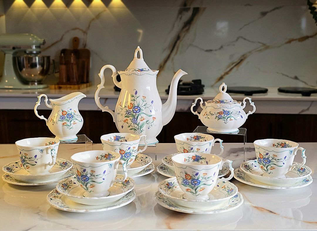 Royal Albert Hamlyn Coffee Set (Category: Coffee & Tea Tableware) located in Compostela. Submitted by curatedcabinetcebu (Listing ID 1470547886, Image 1). Description: - Authentic Royal Albert bone china tea set in Hamlynpattern - Complete 6-person service including large coffee pot, creamer, and lidded sugar bowl - Includes 6 teacups, matching saucers and cake plates - Elegant white background adorned with a vibrant blue and orange floral motif 