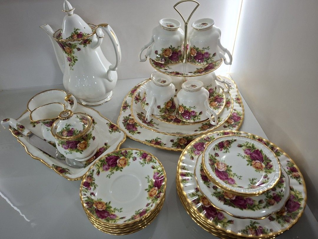 Royal Albert Old Country Roses Tea Set (Category: Coffee & Tea Tableware) located in Antipolo. Submitted by cloudpetals.01 (Listing ID 1470460704, Image 2). Description: - Authentic Royal Albert Old Country Roses porcelain tea set - Includes: tall teapot, two-tier display stand with cups, saucers, small plates, creamer jug, sugar bowl, serving tray, and matching knife - Design: White porcelain with vibrant red and yellow roses, finished with gold