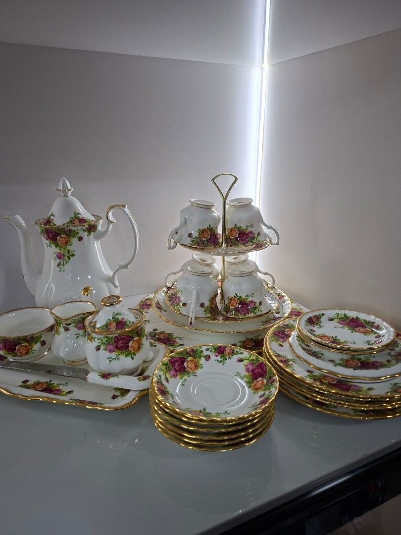 Royal Albert Old Country Roses Tea Set (Category: Coffee & Tea Tableware) located in Antipolo. Submitted by cloudpetals.01 (Listing ID 1470460704, Image 3). Description: - Authentic Royal Albert Old Country Roses porcelain tea set - Includes: tall teapot, two-tier display stand with cups, saucers, small plates, creamer jug, sugar bowl, serving tray, and matching knife - Design: White porcelain with vibrant red and yellow roses, finished with gold