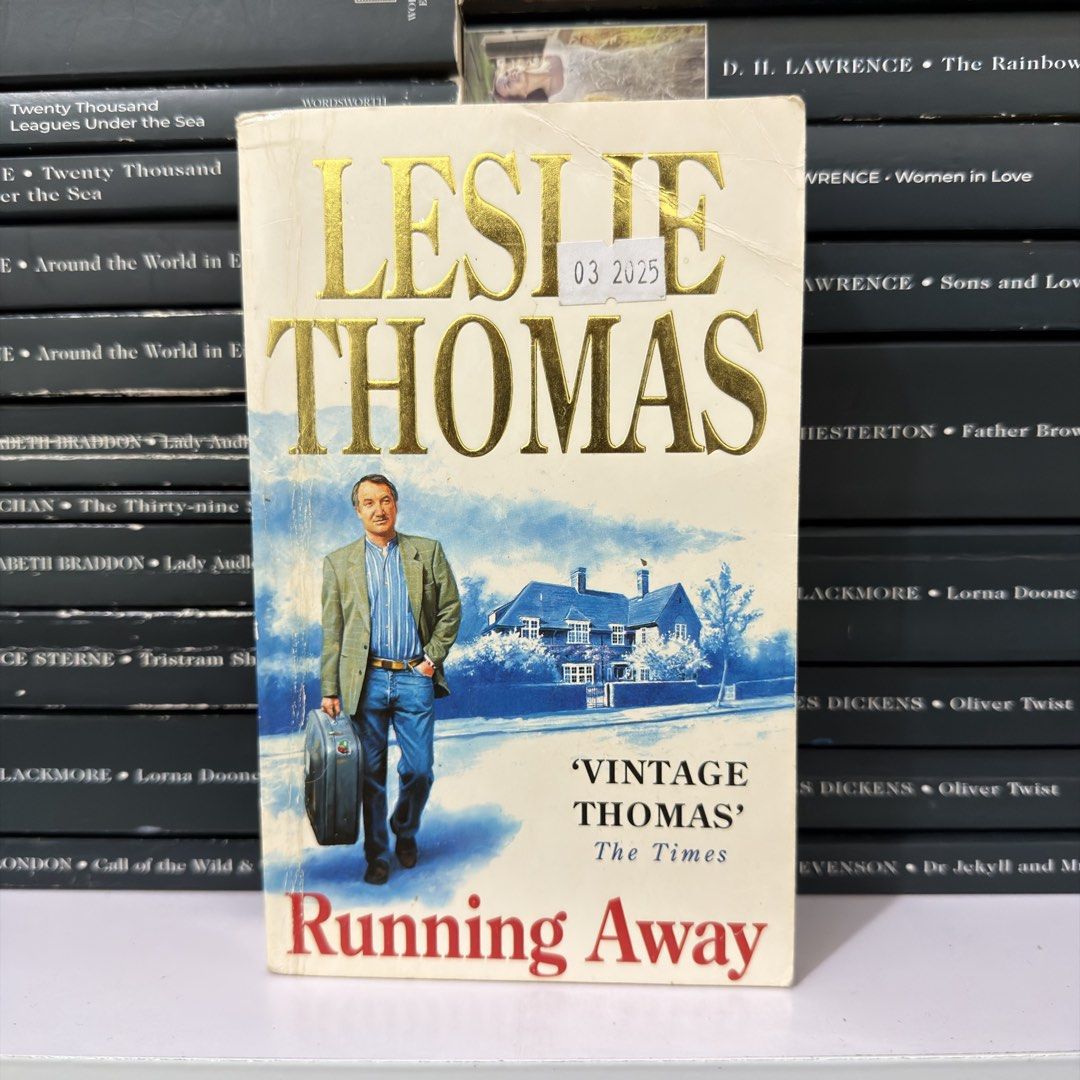Running Away by Leslie Thomas Paperback Novel (Category: Storybooks) located in Lingayen. Submitted by readwjane (Listing ID 1470480002, Image 1). Description: - Title: Running Away by Leslie Thomas - Format: Paperback - Cover: Unique artwork featuring a man with a suitcase and elegant gold lettering - Condition: Normal edge wear from reading and storage, with clean inside pages - Perfect for: Fiction book collectors and readers.