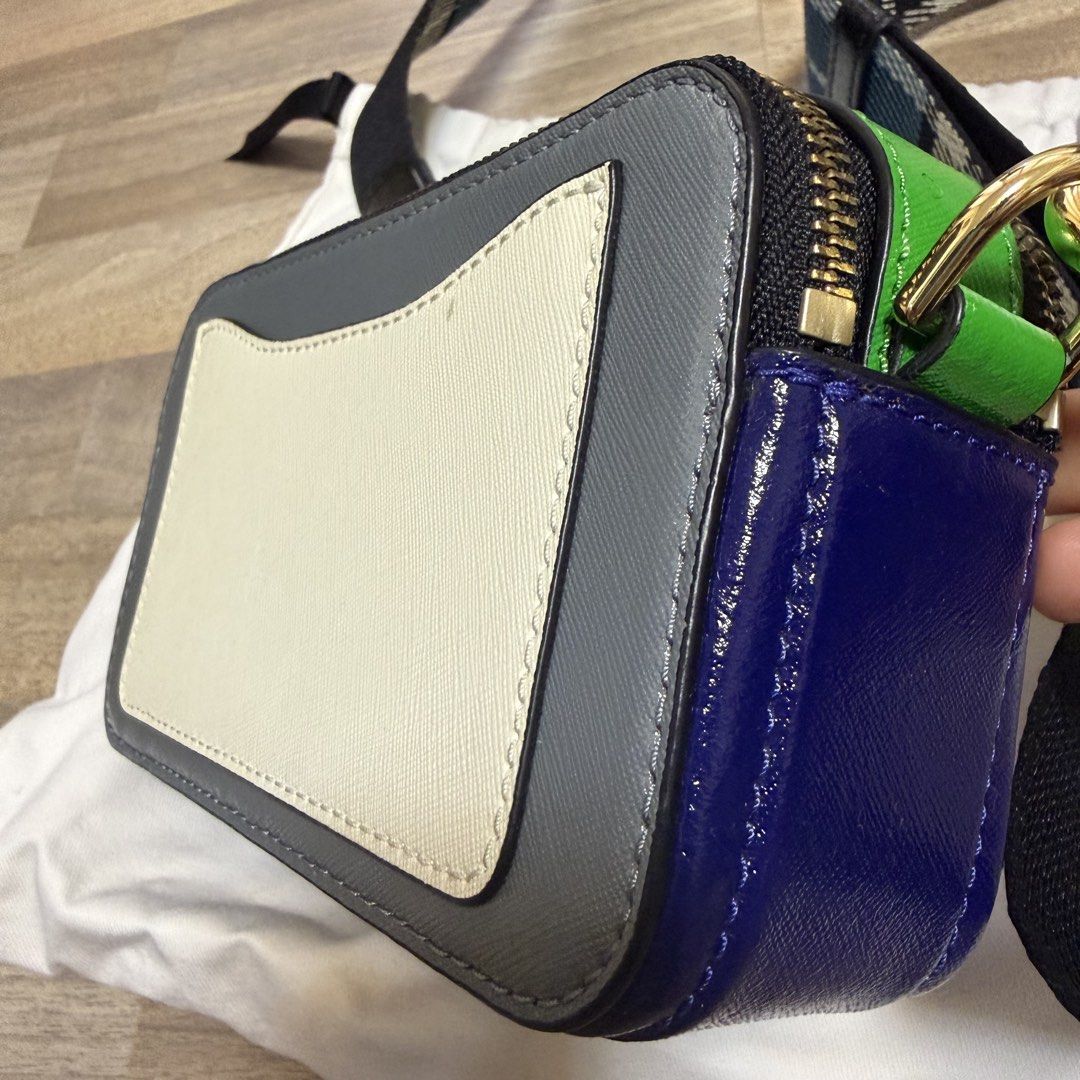 RUSH Marc Jacobs Snapshot Camera Bag Multi-Color (Category: Luxury Bags & Wallets) located in Quezon City. Submitted by bmason0408 (Listing ID 1470389177, Image 3). Description: - Multi-color Marc Jacobs Snapshot camera bag. - Grey front and back, bright green top gusset, blue side panels, white accent pocket patch on reverse. - Gold hardware - Thick strap in blue, black, and white plaid - Includes white dust bag - Compact crossbody style with do