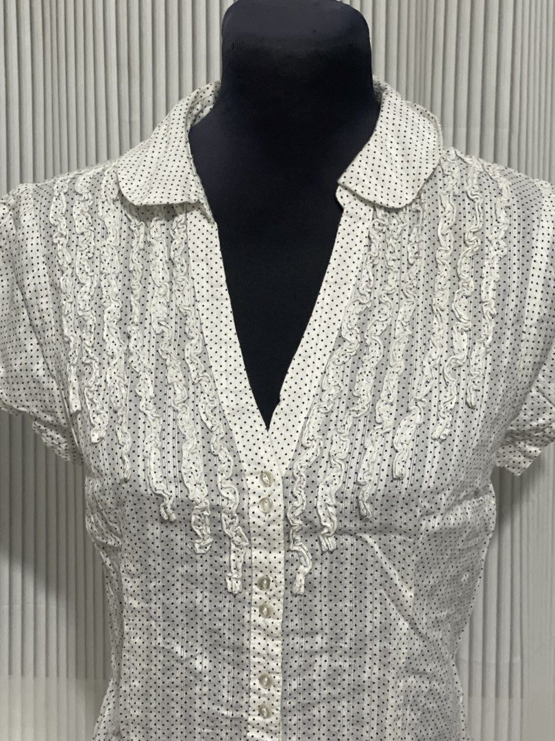 RW & Co. White Suble Dot Design Polo Top (Category: Others Tops) located in Tuguegarao City. Submitted by ziggerryy (Listing ID 1470516676, Image 3). Description: No flaws. No holes Fits S-M *white short-sleeve button-front blouse featuring a subtle dot pattern, a classic collar, and delicate vertical ruffle trims along the placket.* .