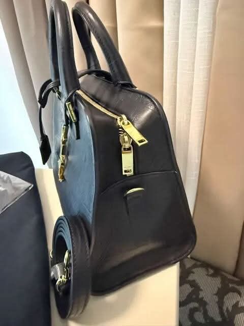Saint Laurent Black Croc Embossed Leather Handbag (Category: Luxury Bags & Wallets) located in Taguig. Submitted by Myclosetdeclutter (Listing ID 1470356599, Image 3). Description: - Brand: Yves Saint Laurent (YSL) - Material: Black leather with crocodile texture - Hardware: Elegant gold-tone accents featuring the classic YSL monogram - Versatility: Includes double top handles and a detachable strap - Closure: Secure top zip closure - Inclusions: