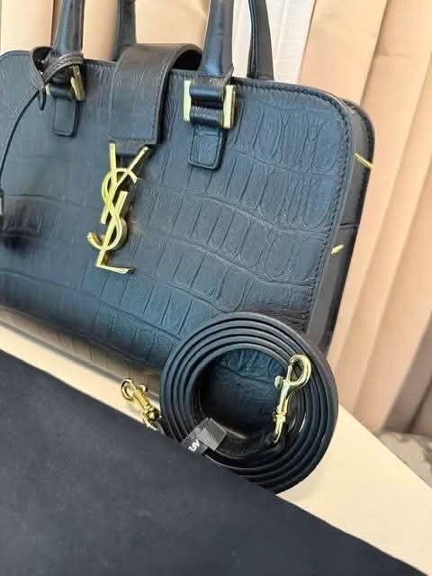 Saint Laurent Black Croc Embossed Leather Handbag (Category: Luxury Bags & Wallets) located in Taguig. Submitted by Myclosetdeclutter (Listing ID 1470356599, Image 2). Description: - Brand: Yves Saint Laurent (YSL) - Material: Black leather with crocodile texture - Hardware: Elegant gold-tone accents featuring the classic YSL monogram - Versatility: Includes double top handles and a detachable strap - Closure: Secure top zip closure - Inclusions: