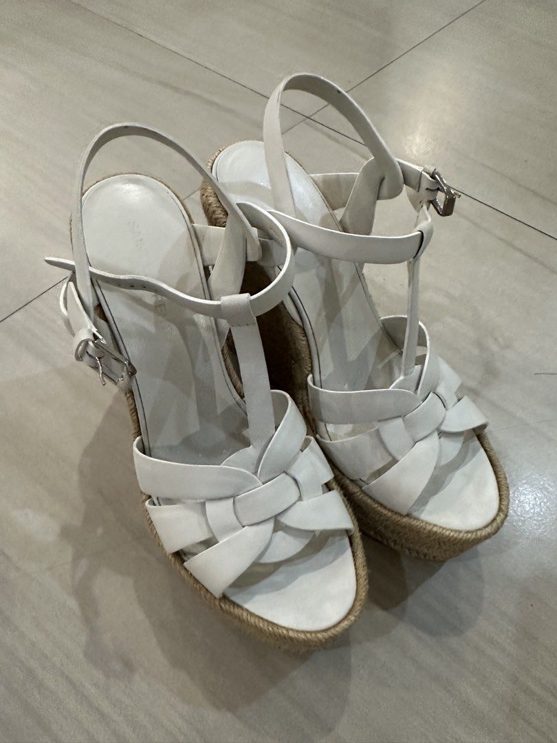 Saint Laurent White Wedge Espadrille Sandals (Category: Wedges) located in Zamboanga. Submitted by joysl_ph (Listing ID 1470500249, Image 1). Description: - Brand: Saint Laurent - Style: White wedge sandals with woven jute platform heels - Design: T-strap with braided leather toe bands and side buckle closures - Condition: Minor wear on soles from testing/light indoor use only - Vibe: Classic summer style, chic and comfortable.