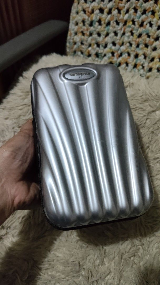 Samsonite 1910 Hard Shell Zippered Travel Pouch (Category: Belt bags, Clutches and Pouches) located in Cebu City. Submitted by lumaynojes00490 (Listing ID 1470497799, Image 3). Description: - Brand: Samsonite 1910 - Color: Sleek silver - Material: Durable hard shell with a structured ridged exterior for extra protection - Closure: Secure all-around zipper - Size: Compact and travel-friendly, fits easily inside larger bags or luggage.