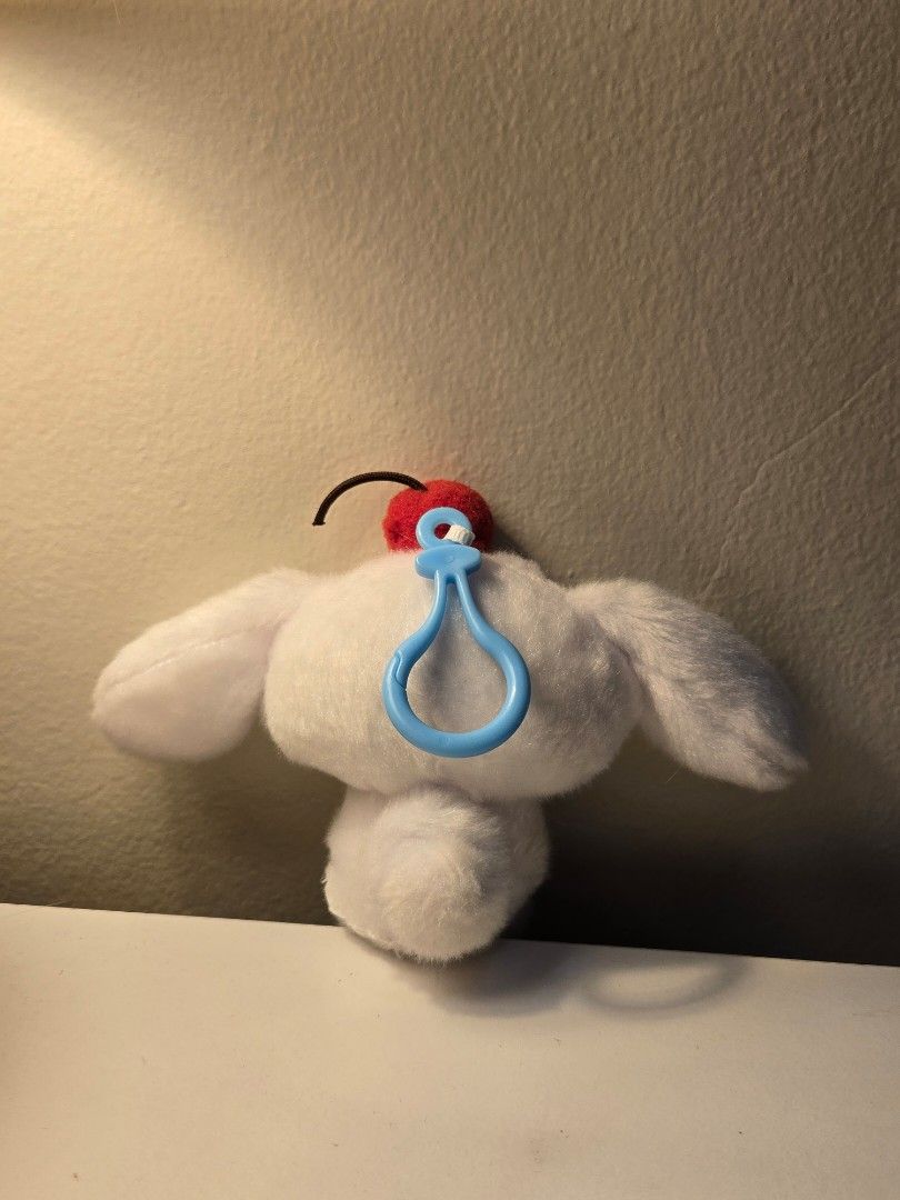 Sanrio Cinnamoroll Cherry Plush Keychain (Category: Plushies & Soft Toys) located in Bulacan. Submitted by matchiii (Listing ID 1470508198, Image 2). Description: - Adorable White Cinnamoroll plush keychain - Features cute blue embroidered eyes and face details - Soft and fuzzy material for a huggable feel - Cute red cherry accent on a brown stem near the ear - Equipped with a light blue plastic snap hook for easy hanging on bags or keys.