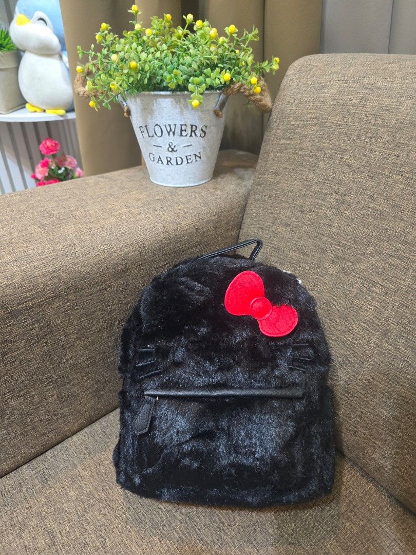 Sanrio Hello Kitty Black Faux Fur Mini Backpack (Category: Backpacks) located in Manila. Submitted by imported_finds (Listing ID 1470490882, Image 2). Description: - ORIGINAL. Sanrio original Kitty mini backpack - Material: Soft and fluffy black faux fur - Design details: Iconic bright red bow and chic gold-toned hardware - Storage: Main compartment with a convenient front zippered pocket - Comfort: Adjustable black shoulder straps for a custom f