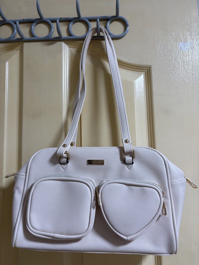 Secosana White shoulder bag with heart pocket (Category: Shoulder Bags) located in Quezon City. Submitted by arinscart (Listing ID 1470504656, Image 1). Description: Condition: Some small scuff marks near the top and zipper area visible in close-up photos. Used once for a concert lang 😊 MOP: GCash, Maribank, BPI MOD: J&T, SDD LOC: QC .