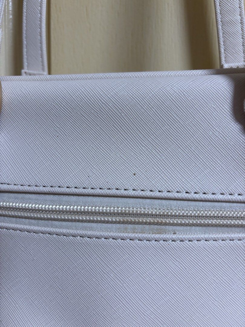 Secosana White shoulder bag with heart pocket (Category: Shoulder Bags) located in Quezon City. Submitted by arinscart (Listing ID 1470504656, Image 3). Description: Condition: Some small scuff marks near the top and zipper area visible in close-up photos. Used once for a concert lang 😊 MOP: GCash, Maribank, BPI MOD: J&T, SDD LOC: QC .