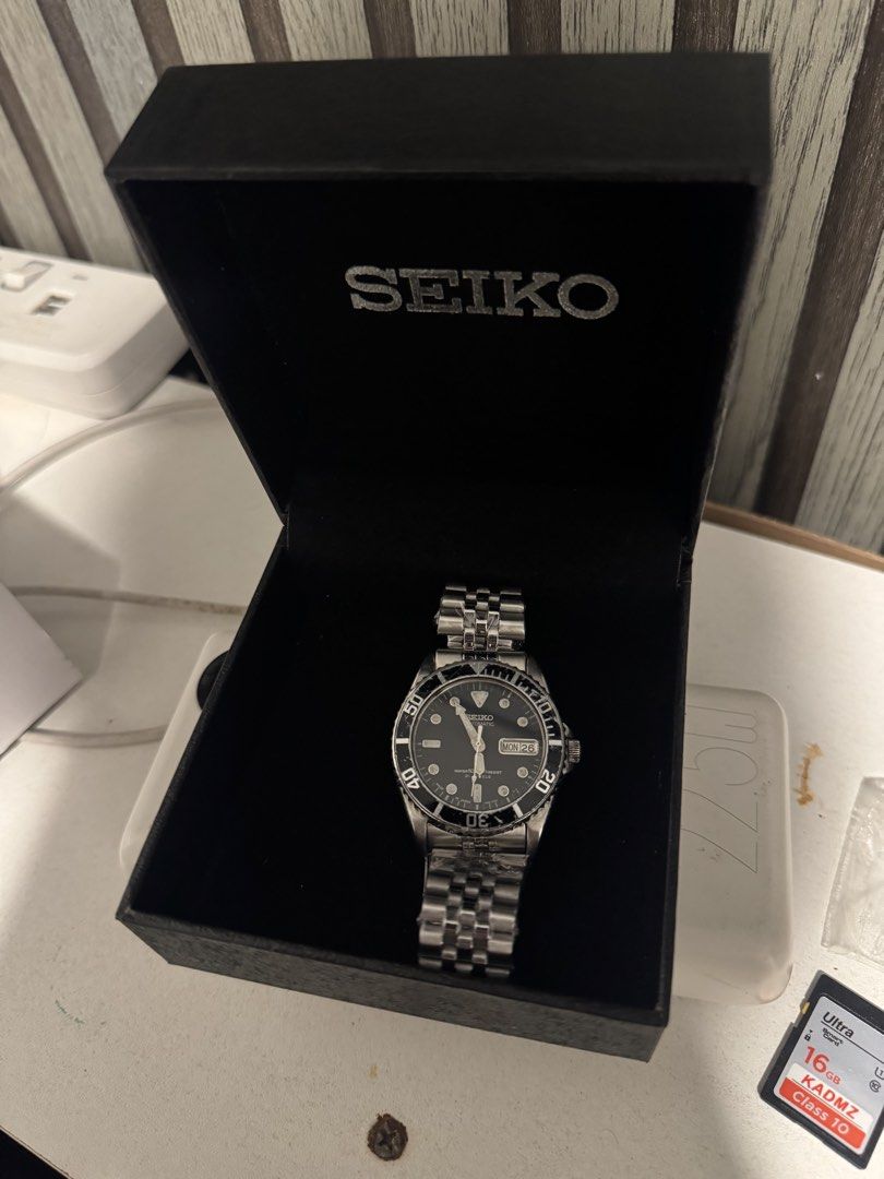 Seiko Submariner 10bar (Category: Men's Watches) located in Manila. Submitted by frierin (Listing ID 1470480066, Image 2). Description: Vintage Seiko automatic watch, 21 jewels movement with day and date window. Black dial, rotating bezel, luminous hands and hour markers. Includes the original Seiko presentation box and a brand new aftermarket jubilee metal bracelet still in its protective plastic packaging. Classic diver aesthetic. Wear on the b