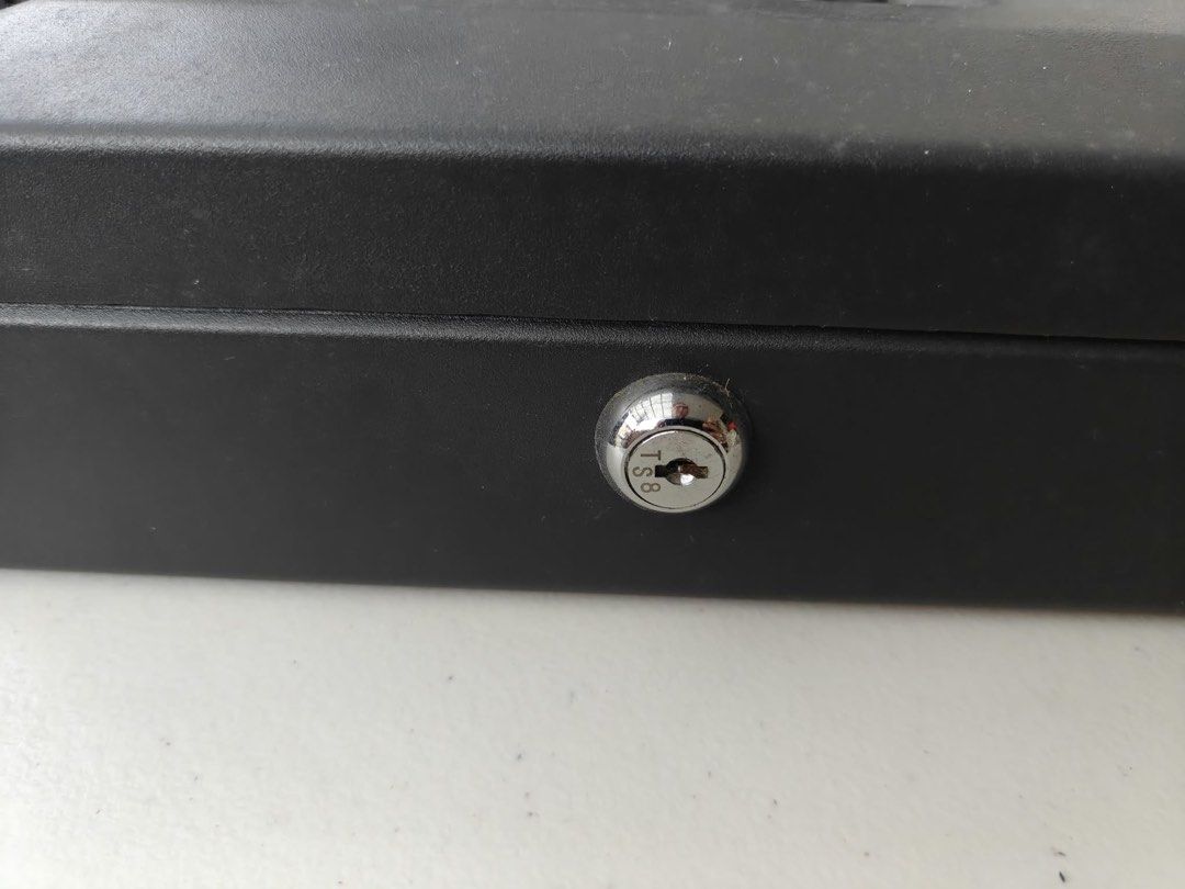 SentrySafe Black Cash Box With Removable Tray (Category: Safe) located in Antipolo. Submitted by tagsale101 (Listing ID 1470461095, Image 2). Description: - Brand: SentrySafe - Color: Classic black - Material: Sturdy metal construction - Security: Key lock on front panel (includes 2 keys in sealed bag) - Tray: Removable gray plastic tray with 6 coin and bill compartments - Storage: Extra space underneath the tray for receipt or document storage -