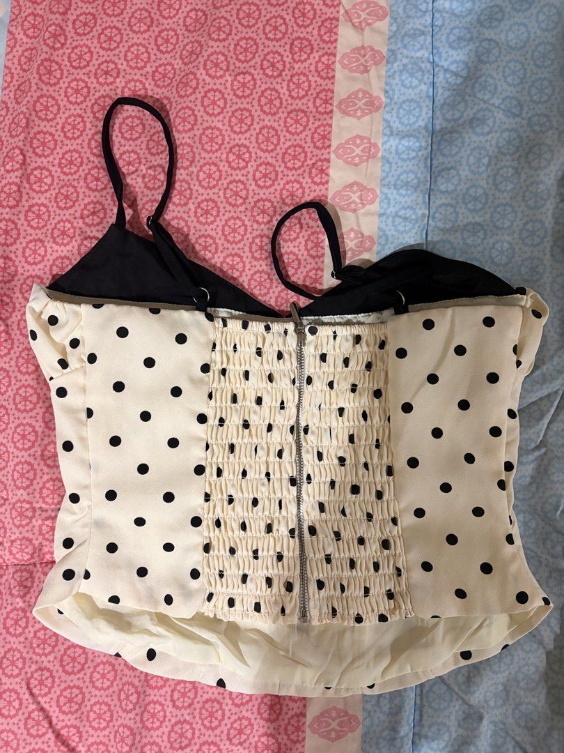 Polka Dot Corset Top (Category: Sleeveless) located in Dasmarinas. Submitted by littleczarmer (Listing ID 1470367221, Image 3). Description: - never worn - bought from kensclothingonline on instagram; bought for 650php - Size: M - dimensions: bust 33-34, waist 27-28, hip 37-38 - Design: Cream and black polka dot with contrast black cups - Features: Adjustable spaghetti straps, ruffled neckline, smocked back panel for comfort, exposed back zipper 