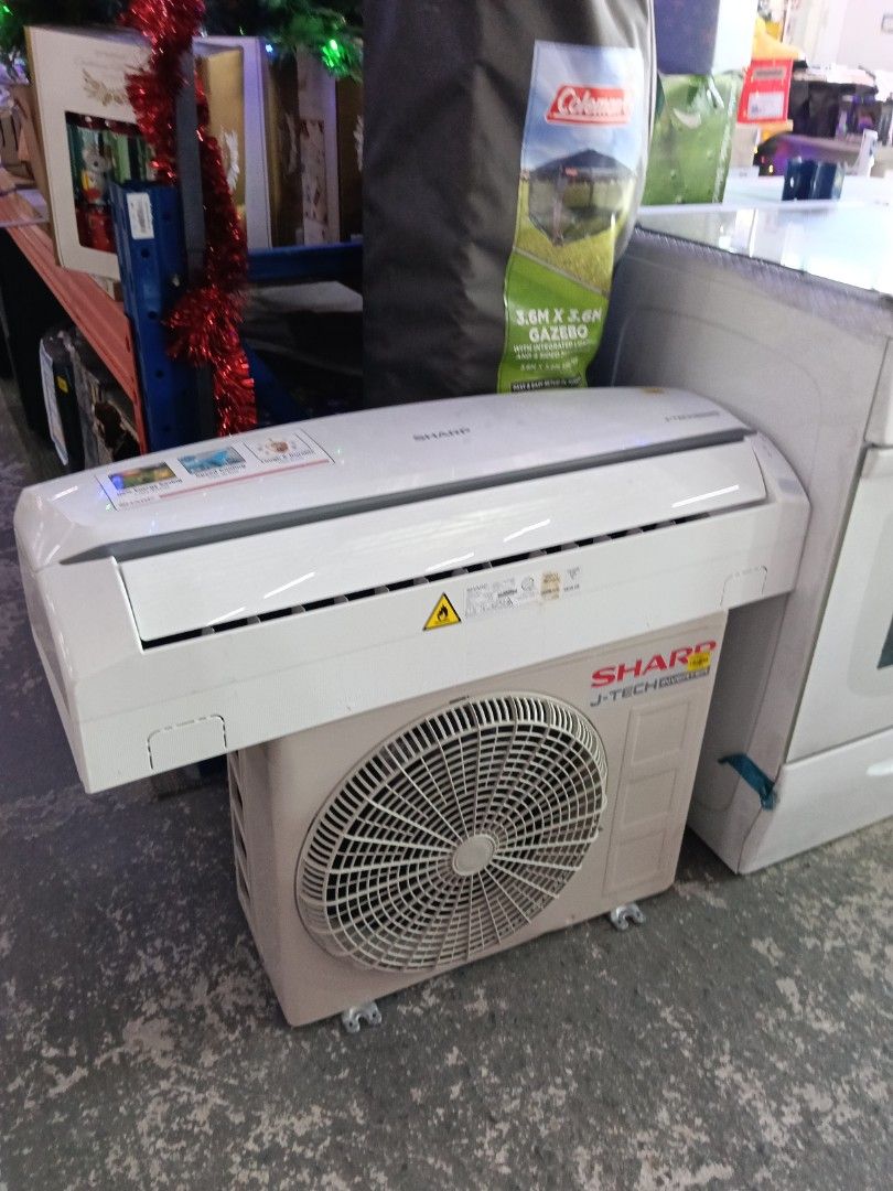 Sharp J-Tech Inverter Air Conditioner Split System (Category: Air Conditioning and Heating) located in Manila. Submitted by jesicahmrsantarosa (Listing ID 1470379291, Image 2). Description: - Brand: Sharp J-Tech Inverter - Type: Split system air conditioner (includes indoor wall unit and outdoor condenser) - Color: Standard white indoor panel, beige outdoor unit with protective fan grille - Features: Reliable cooling and energy-saving inverter te