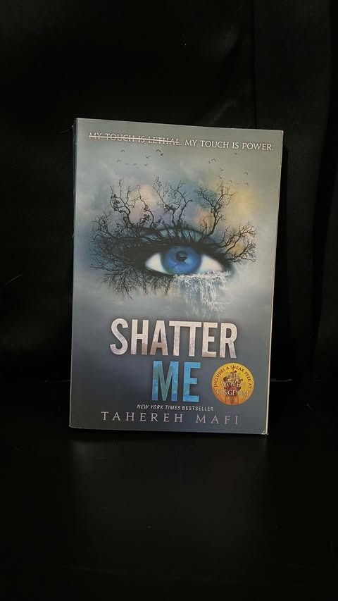 Shatter Me by Tahereh Mafi paperback (Category: Storybooks) located in Lipa City. Submitted by wewez_store (Listing ID 1470477696, Image 1). Description: - Title: Shatter Me by Tahereh Mafi - Format: Paperback with classic blue eye cover - Bonus: Includes a sneak peek at Unravel Me - Genre: YA dystopian fiction - Condition: Clean pages, well-maintained and ready for a new reader.