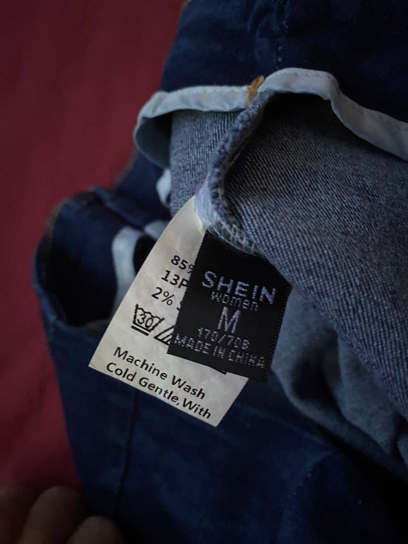 SHEIN Denim Skirt STRETCHABLE (Category: Skirts) located in Manila. Submitted by love_mami (Listing ID 1470450267, Image 2). Description: - Brand: SHEIN - Color: Dark blue wash - Size: M (Tag: 170/70B) 27-28 waist - Design: Front seams with small slit details near the hem - Material: Cotton blend with a bit of stretch for comfort - Care: Machine washable.