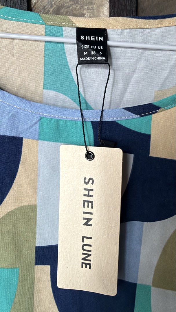 SHEIN LUNE Geometric Pattern Short Sleeve Blouse Size M (Category: Blouses) located in Makati City. Submitted by rocelli28 (Listing ID 1470455371, Image 2). Description: - Brand: SHEIN LUNE - Style: Geometric print color block blouse with round neckline and short sleeves - Colors: Navy blue, teal, pastel yellow, light blue, and white - Size: M (EU 38, US 6) - Material: Smooth, comfortable, lightweight fabric.