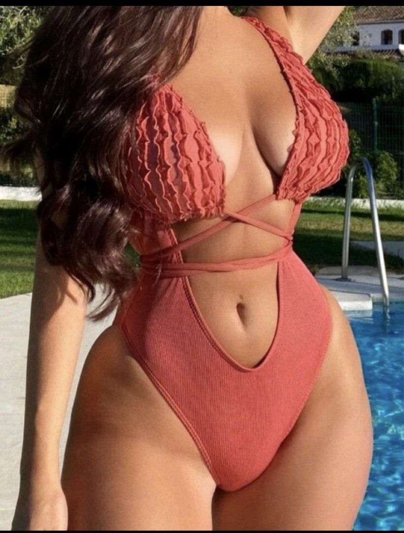 SHEIN Ruffle Cut Out One Piece Swimsuit (Category: Bikinis & Swimsuits) located in Taguig. Submitted by marj.palomo (Listing ID 1470484310, Image 1). Description: - Brand: SHEIN - Condition: Used once only - Color: Terracotta pink - Style: One-piece with deep plunge neckline & high-cut legs - Details: Ruffle textured bust cups, cross-body wrap straps, and waist tie - Fabric: Ribbed texture throughout.