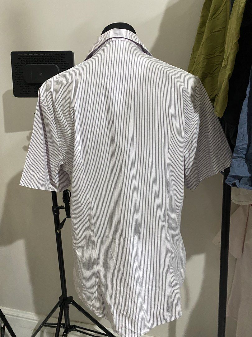 Short Sleeve Striped Button Down Shirt with Embroidery (Category: Shirts) located in Manila. Submitted by mpt99876 (Listing ID 1470496276, Image 3). Description: - Style: Short sleeve button-down shirt - Design: Blue and white vertical stripes with a pointed collar and white front buttons - Detail: Yellow embroidered text on the left chest - Fit: Regular fit, lightweight fabric - Ideal for: Everyday casual wear.