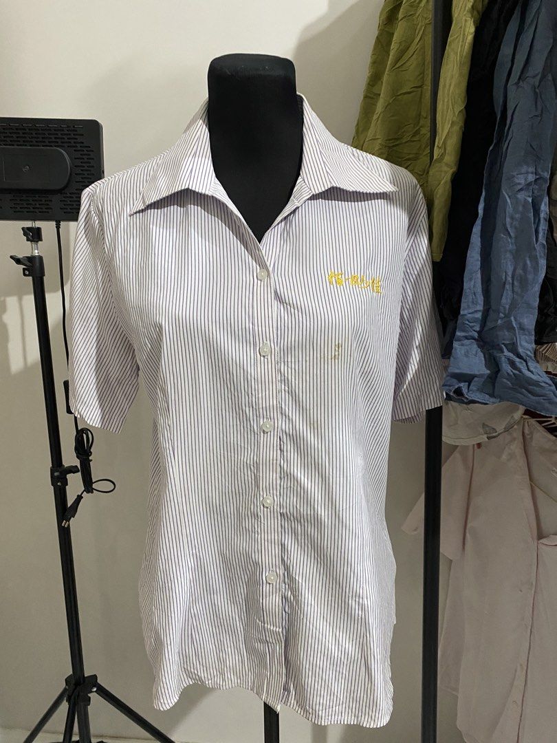 Short Sleeve Striped Button Down Shirt with Embroidery (Category: Shirts) located in Manila. Submitted by mpt99876 (Listing ID 1470496276, Image 2). Description: - Style: Short sleeve button-down shirt - Design: Blue and white vertical stripes with a pointed collar and white front buttons - Detail: Yellow embroidered text on the left chest - Fit: Regular fit, lightweight fabric - Ideal for: Everyday casual wear.