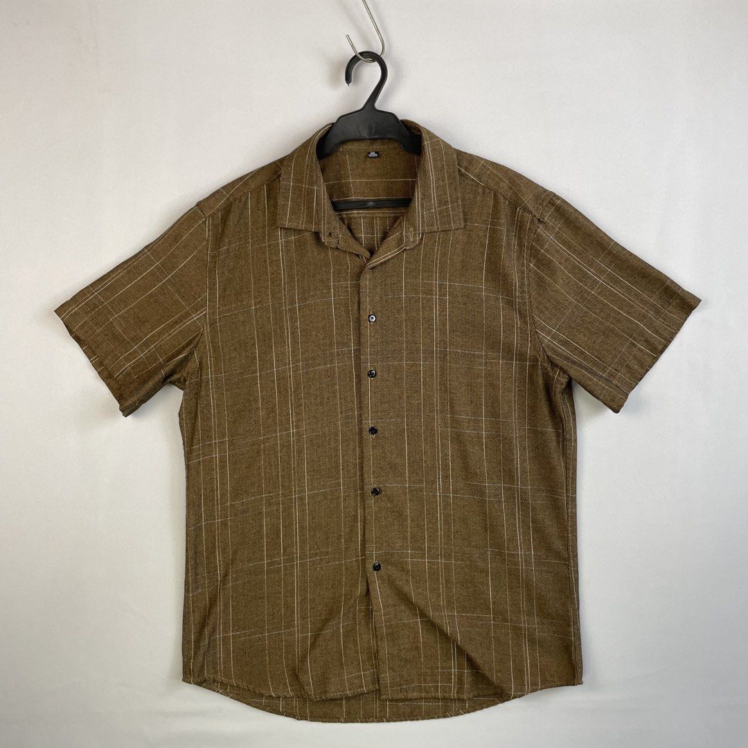 Short-Sleeve Windowpane Grid Check Pattern Button-Down Shirt (Category: Tshirts & Polo Shirts ) located in Norzagaray. Submitted by sevenjscloset (Listing ID 1470507663, Image 1). Description: - Color: Brown - Design: Windowpane grid check pattern with herringbone texture - Tagged Size: 3XL (Fits like Medium to Large) - Measurements: 27" length x 20" width - Model Reference: 5'10", 70kg - Condition: Clean, zero issues, great for everyday casual w