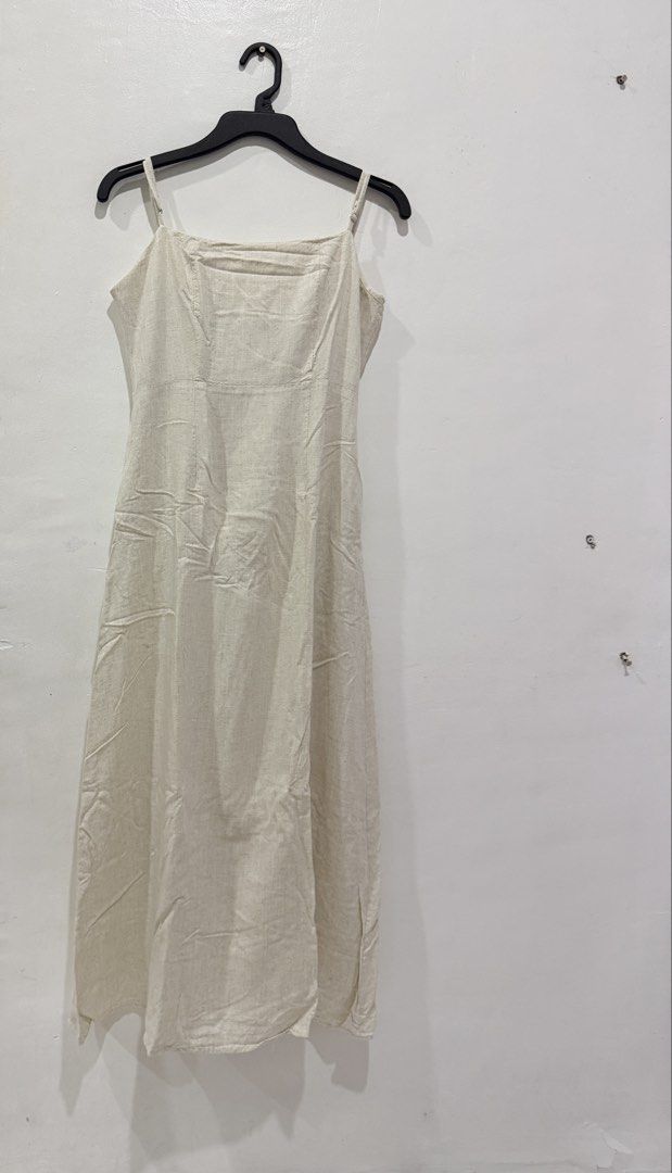Shu Shi Linen Dress (Category: Dresses) located in Makati City. Submitted by prelovedclothes.m (Listing ID 1470467736, Image 2). Description: - Color: Neutral cream - Material: Classic lightweight linen texture - Design: Spaghetti straps, square neckline, and fitted bodice - Fit: Flowy long skirt reaching ankle length.