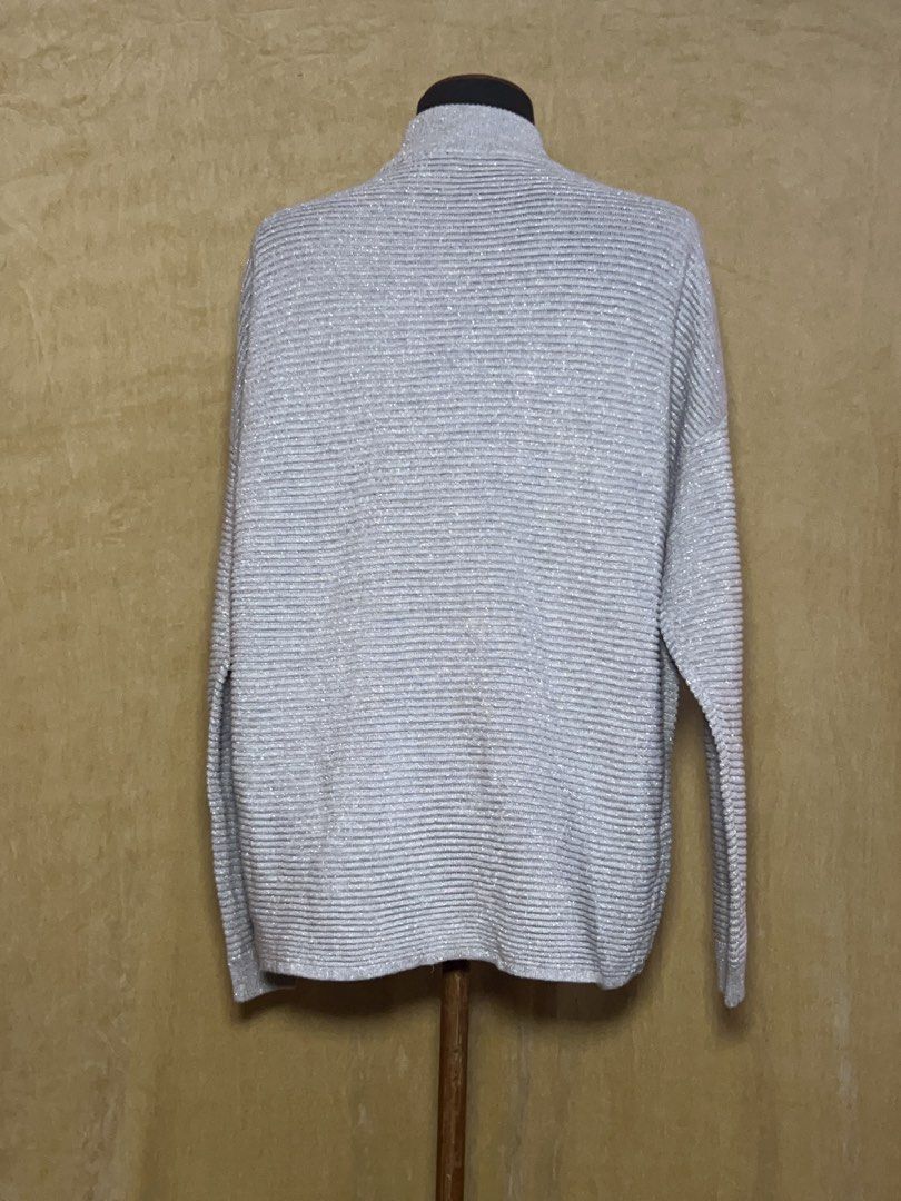 Silver Metallic Turtleneck Ribbed Sweater (Category: Coats, Jackets and Outerwear) located in Batangas. Submitted by mkjgb (Listing ID 1470468907, Image 3). Description: - Color/Finish: Silver with a shiny metallic finish - Fit: Relaxed drop-shoulder fit with long sleeves - Material: Soft, stretchy ribbed knit - Versatility: Perfect for cooler days, holiday parties, or casual wear with jeans - Condition: Brand new / excellent quality.