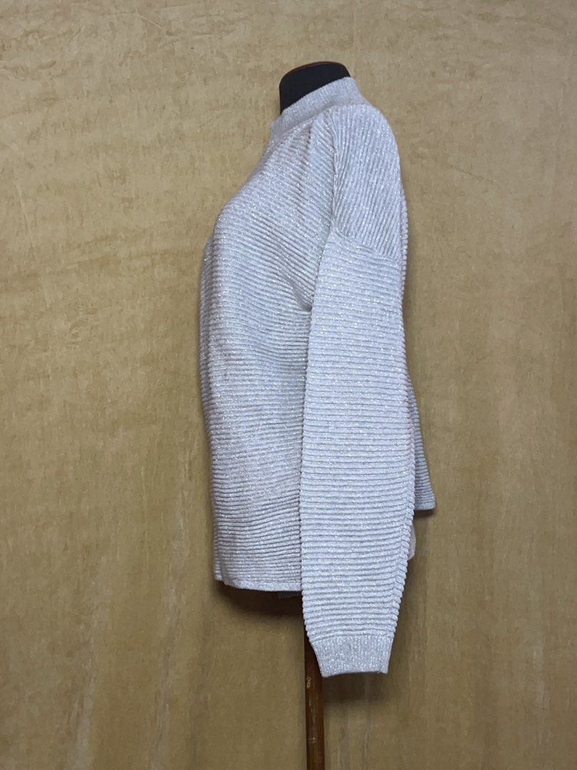 Silver Metallic Turtleneck Ribbed Sweater (Category: Coats, Jackets and Outerwear) located in Batangas. Submitted by mkjgb (Listing ID 1470468907, Image 2). Description: - Color/Finish: Silver with a shiny metallic finish - Fit: Relaxed drop-shoulder fit with long sleeves - Material: Soft, stretchy ribbed knit - Versatility: Perfect for cooler days, holiday parties, or casual wear with jeans - Condition: Brand new / excellent quality.