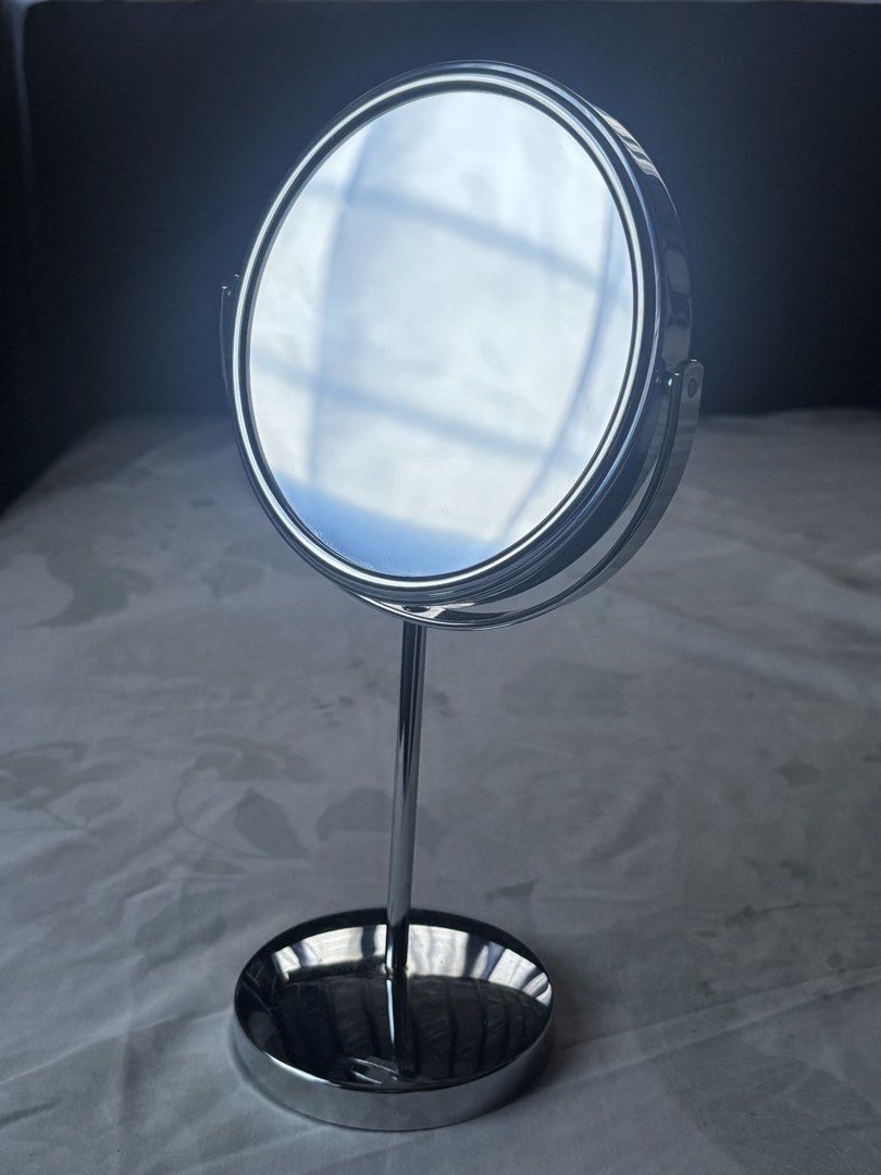 Silver Tabletop Makeup Mirror (Category: Mirrors) located in Makati City. Submitted by dharma444 (Listing ID 1470372638, Image 3). Description: Rfs: Decluttering - Double-sided circular tabletop mirror with full 360-degree rotation - Polished silver finish. Makinis. - Tall stem with a weighted circular base - Has a non-slip at the bottom of the base. MOP: GCash ONLY..