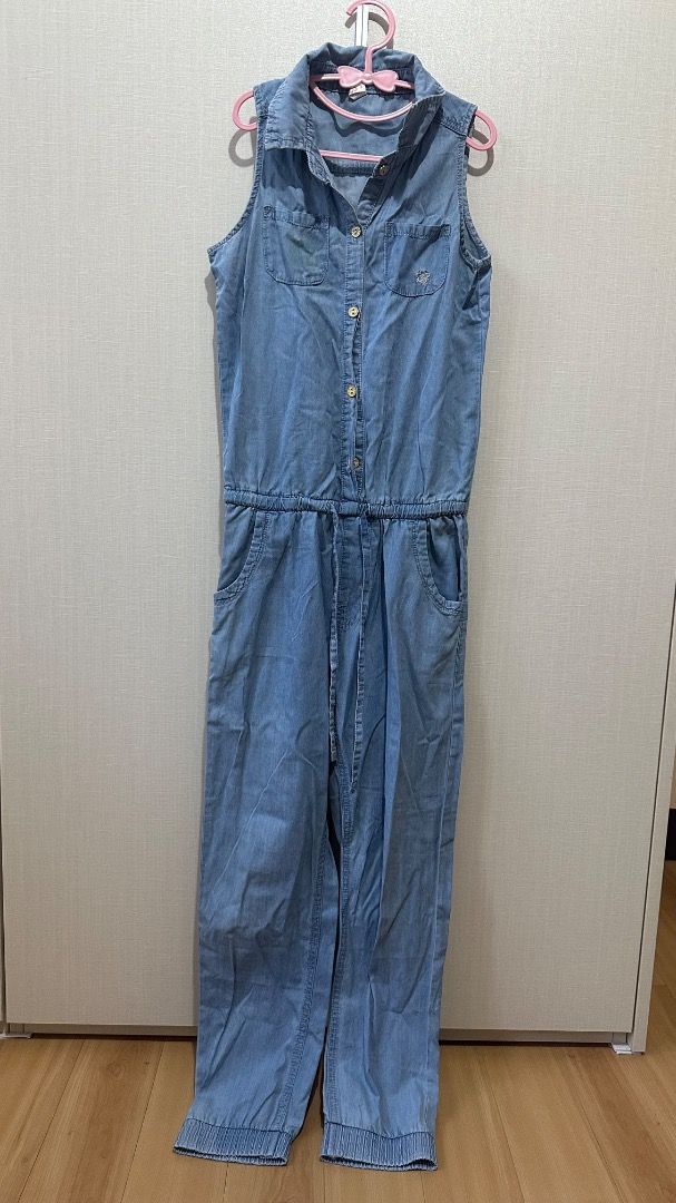 Sleeveless Light Blue Denim Jumpsuit with Drawstring Waist (Category: Jumpsuits) located in Cavite. Submitted by bravesoul99 (Listing ID 1470441422, Image 1). Description: Size 12 on tag fits 7-8yo - Color/Material: Light blue soft denim, easy to slip on - Design: Sleeveless, button-down front with metal hardware - Fit: Adjustable drawstring waist for a flattering shape - Pockets: Two chest pockets (with cute embroidered flower on the left) plus 