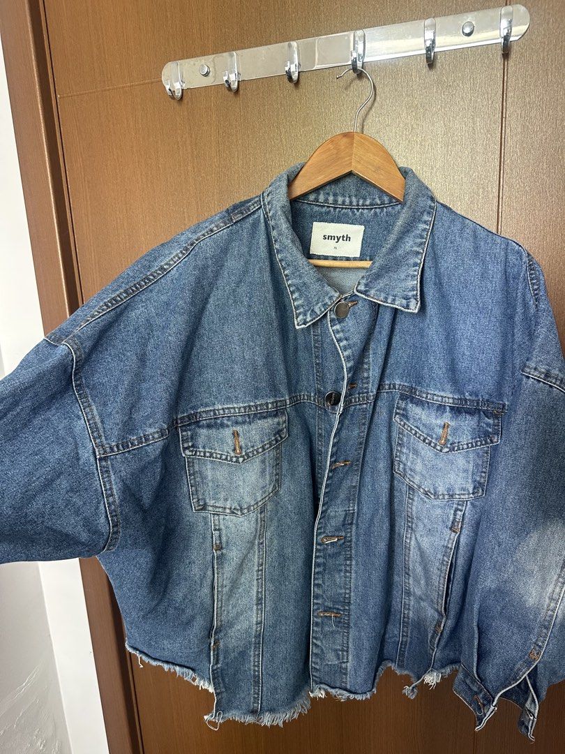 Smyth Oversized Raw Hem Denim Jacket (Category: Coats, Jackets and Outerwear) located in Mandaluyong City. Submitted by fourleafcloverrrr (Listing ID 1470360038, Image 1). Description: Product Details: Brand: Smyth Size: Extra Large (XL) Fit: Oversized / Drop-Shoulder Color: Medium Blue Denim Wash Design Features: Raw distressed frayed hem at the bottom Custom Smyth metal shank buttons Two front chest flap pockets + side hand pockets Buttoned cuf