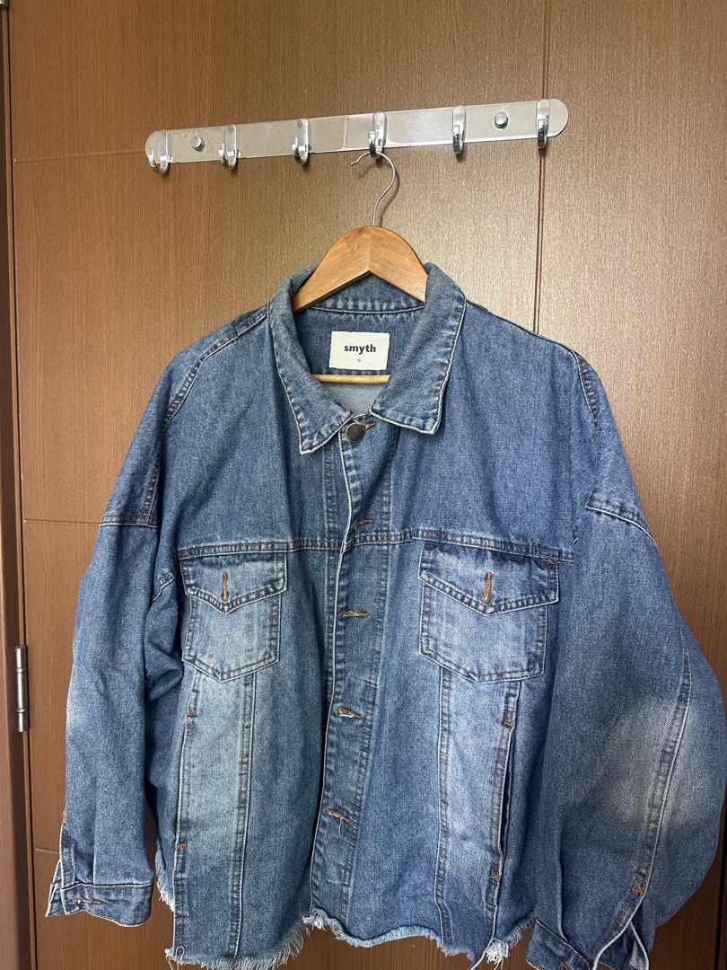 Smyth Oversized Raw Hem Denim Jacket (Category: Coats, Jackets and Outerwear) located in Mandaluyong City. Submitted by fourleafcloverrrr (Listing ID 1470360038, Image 2). Description: Product Details: Brand: Smyth Size: Extra Large (XL) Fit: Oversized / Drop-Shoulder Color: Medium Blue Denim Wash Design Features: Raw distressed frayed hem at the bottom Custom Smyth metal shank buttons Two front chest flap pockets + side hand pockets Buttoned cuf
