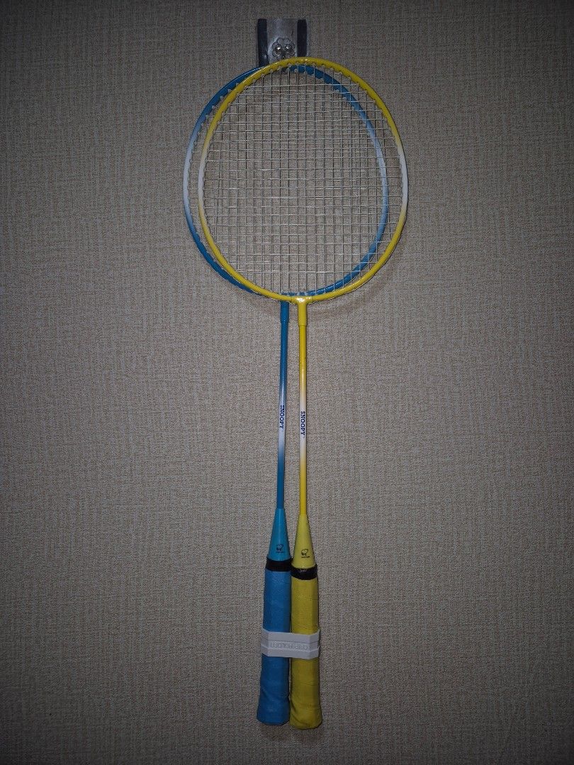 Snoopy Badminton Racket Set with Yellow Storage Bag (Category: Racket and Ball Sports) located in Manila. Submitted by rpaul88 (Listing ID 1470532898, Image 3). Description: - Set of 2 Snoopy badminton rackets (Blue and Yellow) - Includes matching yellow zip carry bag with Snoopy graphics - Wrapped handles with white grip holder clips included - Strings are intact and tight on both frames - Clean condition, perfect for casual park or beach games.