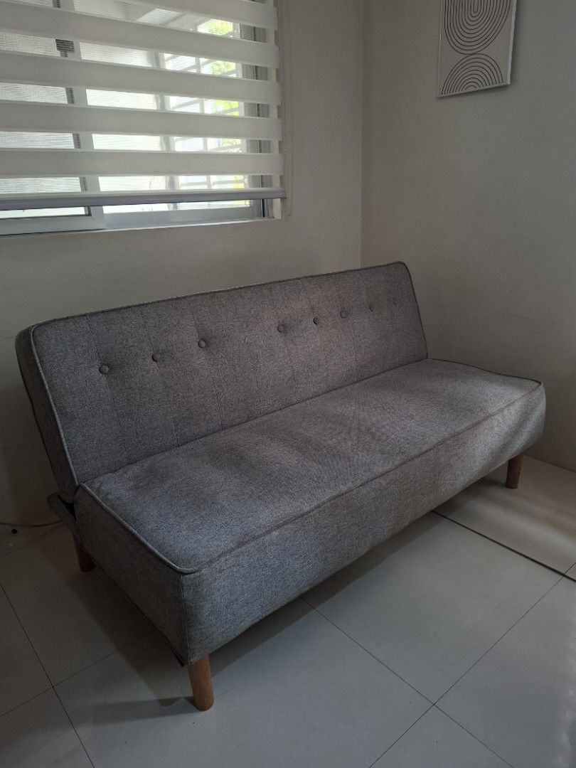 Sofa Bed Grey Fabric with Wooden Legs (Category: Sofas) located in Quezon City. Submitted by shesells17 (Listing ID 1470476767, Image 1). Description: Sofa Bed - Grey fabric with stylish button tuftings - Light wooden legs - Easily converts Flat to Seated position - Comfortable padded seating for everyday use Width x Length: 38" x 55" Height (from floor): 15" Foam Thickness: 7" 📍 Sikatuna Village, QC 🛻 Pick up only - Lalamove SF c/o Buyer .