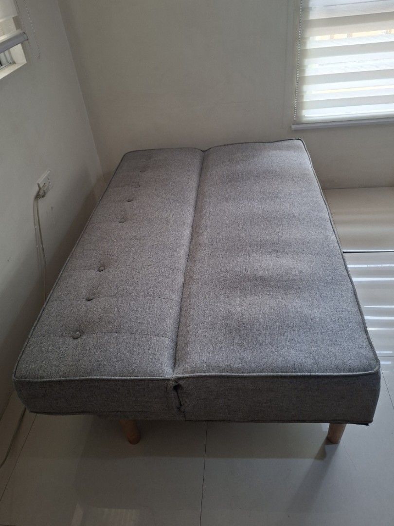 Sofa Bed Grey Fabric with Wooden Legs (Category: Sofas) located in Quezon City. Submitted by shesells17 (Listing ID 1470476767, Image 3). Description: Sofa Bed - Grey fabric with stylish button tuftings - Light wooden legs - Easily converts Flat to Seated position - Comfortable padded seating for everyday use Width x Length: 38" x 55" Height (from floor): 15" Foam Thickness: 7" 📍 Sikatuna Village, QC 🛻 Pick up only - Lalamove SF c/o Buyer .