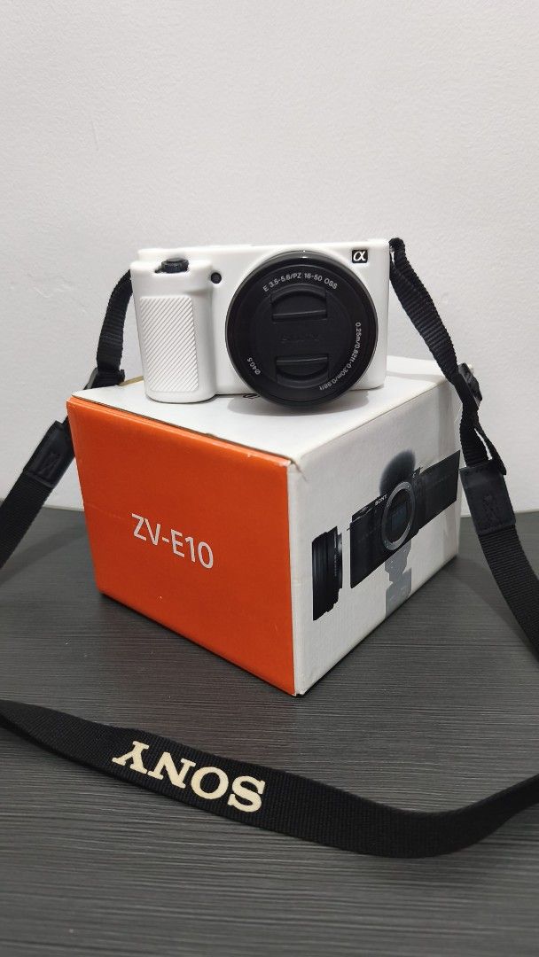 Sony ZV-E10 Mirrorless Camera with 16-50mm Lens (Category: Cameras) located in Marikina City. Submitted by shopapao (Listing ID 1470446284, Image 1). Description: - Sony ZV-E10 mirrorless camera body - E 3.5-5.6/PZ 16-50 OSS lens with clean glass - White silicone protective body case - Original black Sony neck strap - Dual battery charger and power adapter - Complete with original box, manuals, and customer registration form - All-in-one vlogging