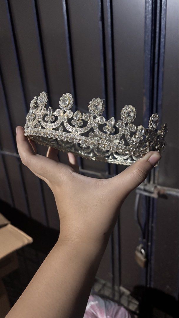 Sparkly Rhinestone Crown Tiara Headpiece (Category: Hair Accessories) located in Caloocan City. Submitted by boldcrystal.64c51d (Listing ID 1470528955, Image 2). Description: - Color/Material: Silver-tone metal covered in clear rhinestones and crystals - Design: Ornate scrollwork with tall peak details and heavy embellishment - Condition: Very clean, all stones are fully intact - Fit: Secure and comfortable on the head - Occasion: Ideal for proms