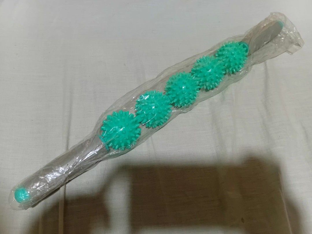 Spiky massage roller stick green handheld muscle roller (Category: Massage Devices) located in Manila. Submitted by seesalt (Listing ID 1470514400, Image 2). Description: for sale.massage rollong pin - Item: Brand New Green Handheld Muscle Roller Stick - Condition: Still sealed inside original clear plastic packaging - Design: Plastic rod featuring 5 spiky spinning balls - Benefits: Effectively relieves muscle tension, knots, and soreness - Usage