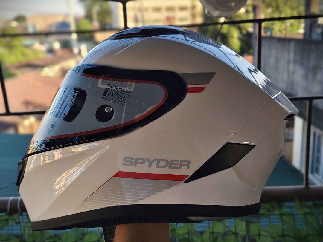 Spyder EOX Full Face Helmet White Size XL (Category: Bicycles) located in Manila. Submitted by kuys_vince. (Listing ID 1470554882, Image 3). Description: Spyder EOX full face motorcycle helmet. Gloss white finish with grey and red graphics. Size XL, fits 61 to 62 centimeters. ECE 22.06 safety certified. Pinlock 70 ready visor with protective sticker still attached. Quick release retention system, multi-density EPS liner, and ABS composite shell. 