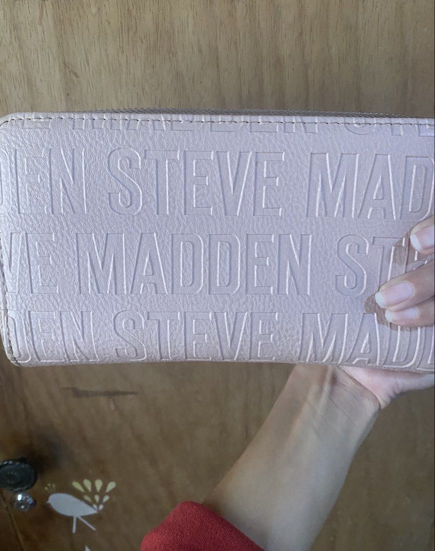 Steve Madden Pink Wristlet Wallet (Category: Wallets & Card holders) located in Bulacan. Submitted by madchen05 (Listing ID 1470357555, Image 2). Description: Steve Madden Pink Wristlet Wallet 🌟Color: Pastel pink with all-over debossed logo 🌟Includes: Matching wrist strap for easy carrying 🌟Interior: Multiple card slots, ID window, and zippered coin compartment 🌟Hardware: Silver-tone with metal logo bar 🌟Flaws: Scratches on metal logo bar & 